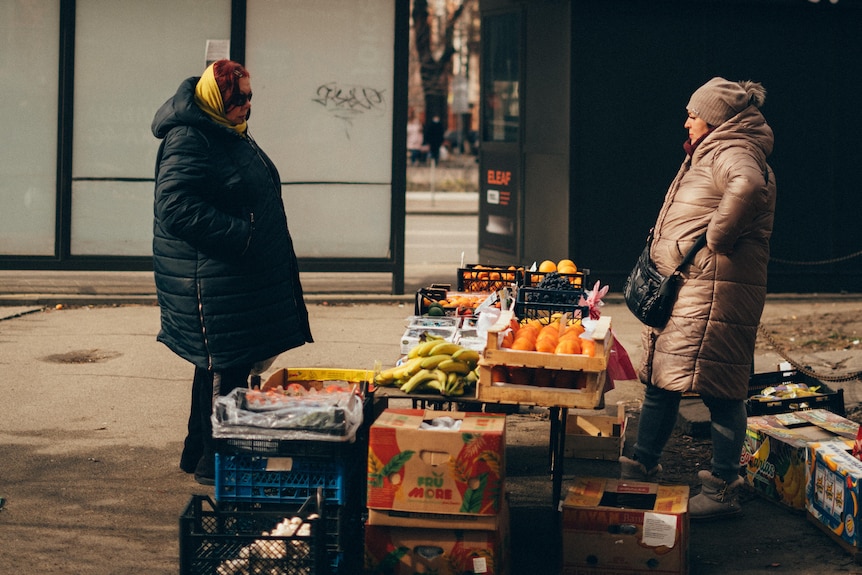 Women set up stalls in the streets of Kyiv.