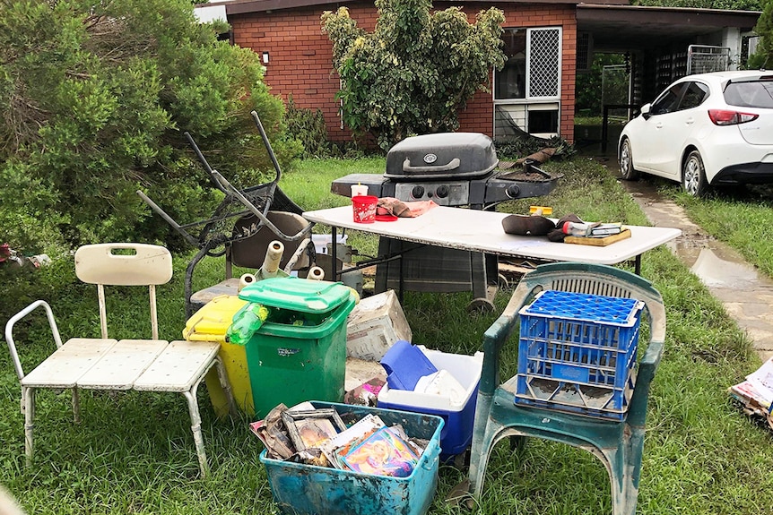 Damaged furniture and possession on the front lawn of Donald Mosby's flood-ravaged home.