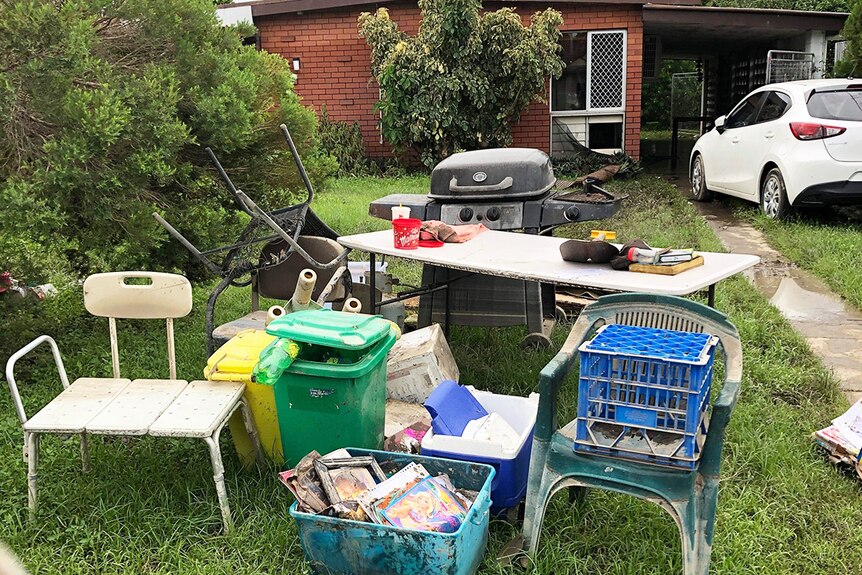 Damaged furniture and possession on the front lawn of Donald Mosby's flood-ravaged home.