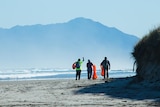 Volunteers walking Ocean Beach