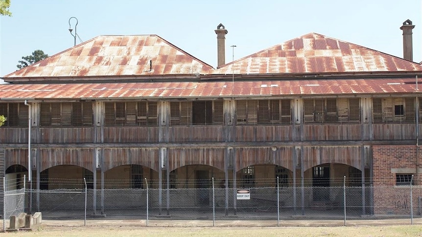 A dilapidated wooden building, with a rusted iron roof