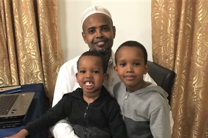 Shirshore Hirad smiles with two of his children.