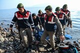 Turkish gendarmes carry the body of an asylum seeker