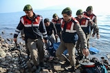 Turkish gendarmes carry the body of an asylum seeker