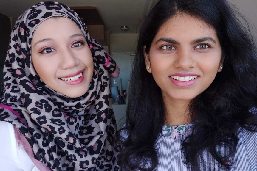 Two girls smiling.