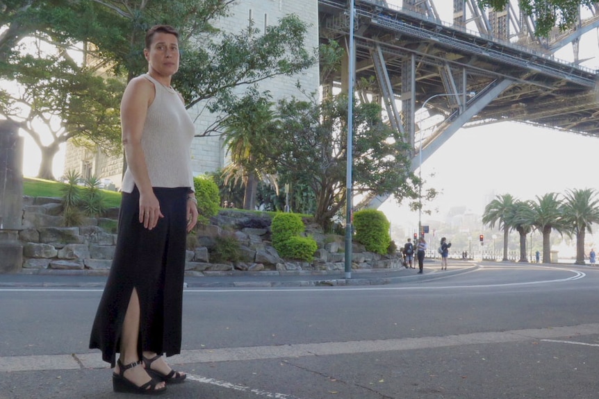 Helen McMaugh stands under a pylon of the Habour Bridge