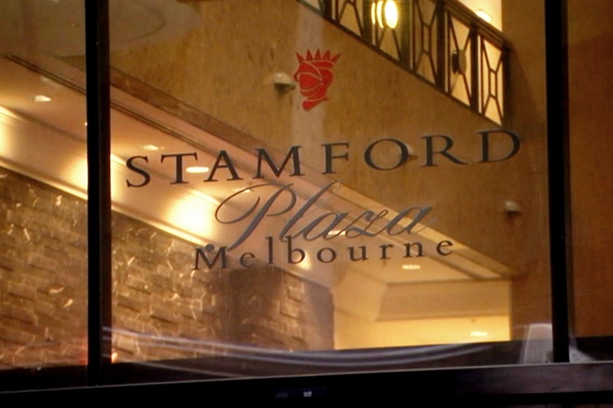 The window of the Stamford Plaza Melbourne with the building's luxurious old interior in the background.