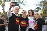 Malcom Turnbull, Tanya Plibersek, Allegra Spender, and Lucy Turnbull take a selfie wearing "Yes" campaign shirts.