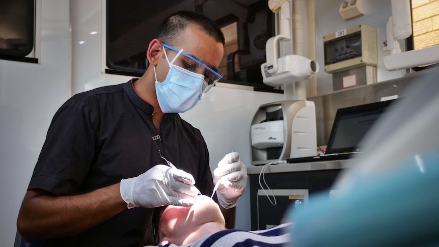 Dr Jalal Khan at work, overlooking a patient.