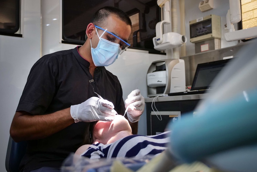 Dr Jalal Khan at work, overlooking a patient.