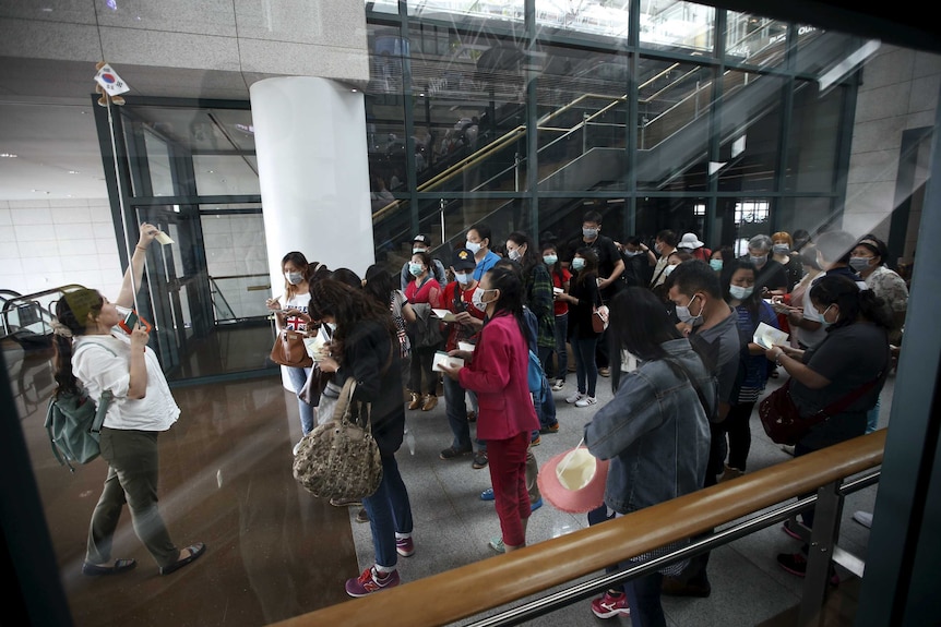 South Korean commuters wear face masks to prevent the spread of MERS