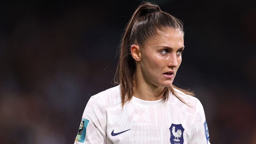 A French World Cup player looks to her left during a match.