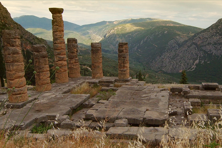 A view of the Temple of Apollo ruins in Delphi, Greece in the day time.