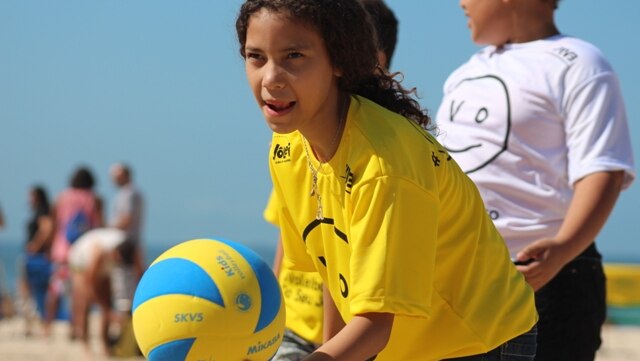 A child from a Rio favela at a beach volleyball clinic in Copacabana.