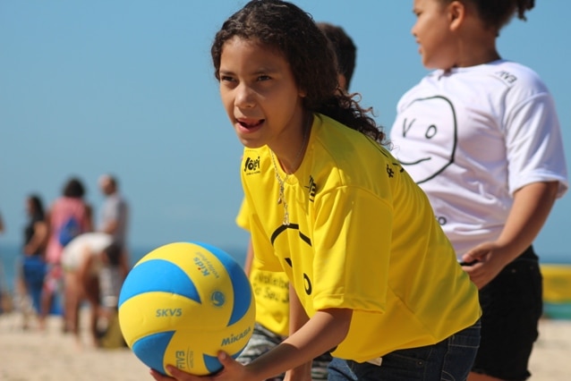 A child from a Rio favela at a beach volleyball clinic in Copacabana.