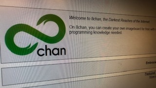 The 8chan website with the green logo and a banner reading: Welcome to 8chan, the Darkest Reaches of the Internet