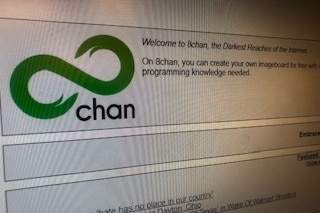 The 8chan website with the green logo and a banner reading: Welcome to 8chan, the Darkest Reaches of the Internet