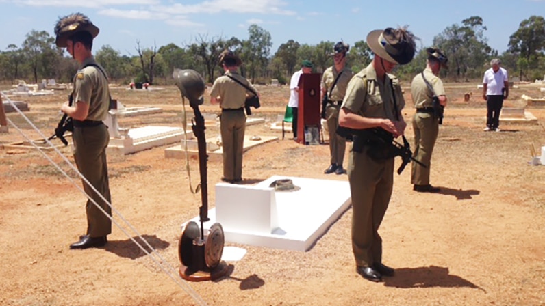 Soldiers at attention at the graveside of Indigenous digger Charles Blackman