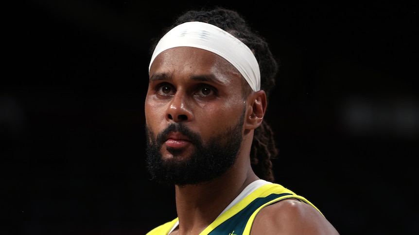 Patty Mills looks on during a Boomers' game at the Tokyo Olympics.
