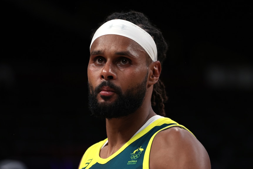 Patty Mills looks on during a Boomers' game at the Tokyo Olympics.