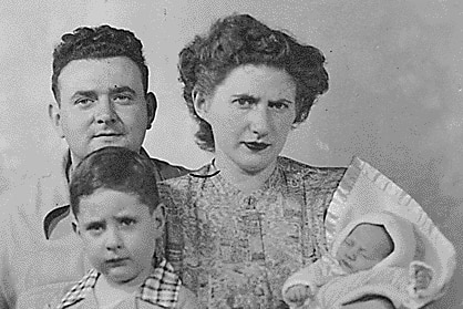 Black and white passport photo of Ruth and David Greenglass with a toddler and a baby.