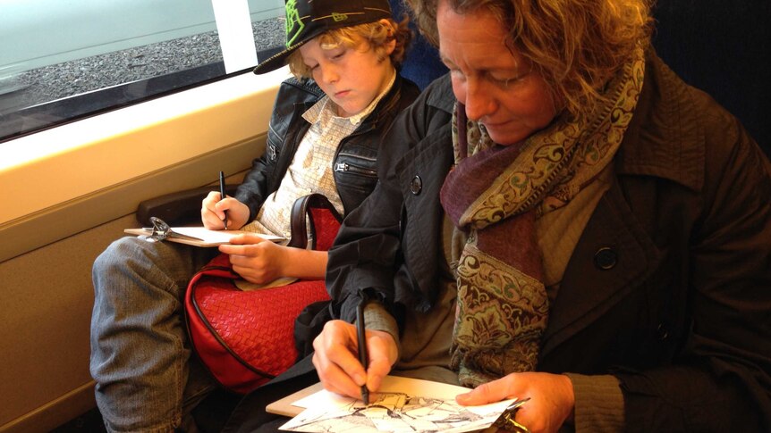 Sarah Archard and her son sketch while travelling on a Bendigo V/Line train.