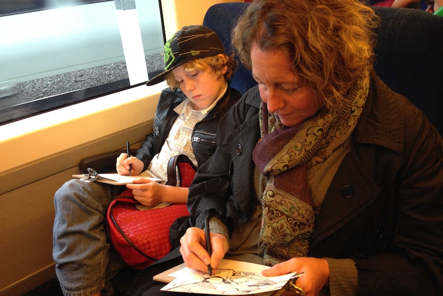 Sarah Archard and her son sketch while travelling on a Bendigo V/Line train.
