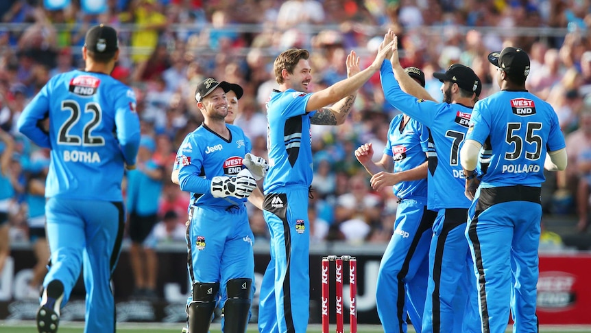 Kane Richardson of the Adelaide Strikers is congratulated by teammates after getting the wicket of Ben Dunk of the Hobart Hurricanes