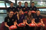 History makers ... The top picks in the AFL Women's Draft pose for photographers in Melbourne