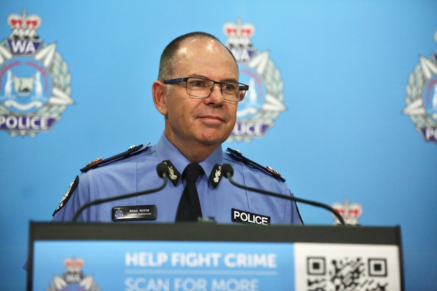 A police officer in front of a podium