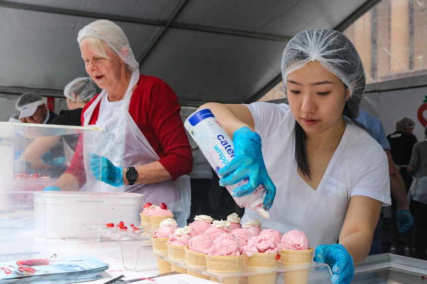 Volunteers making ice-creams.