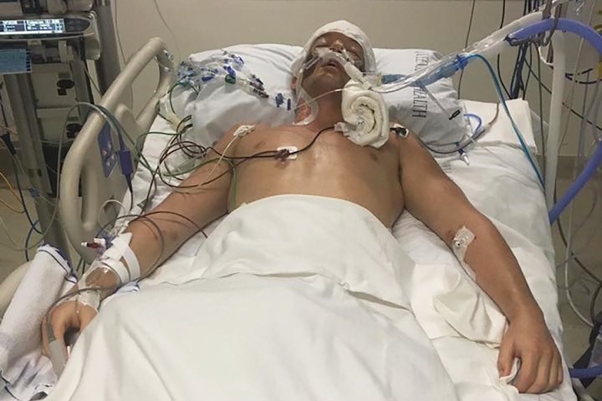Glenn Dickson in a coma after being attacked by a shark