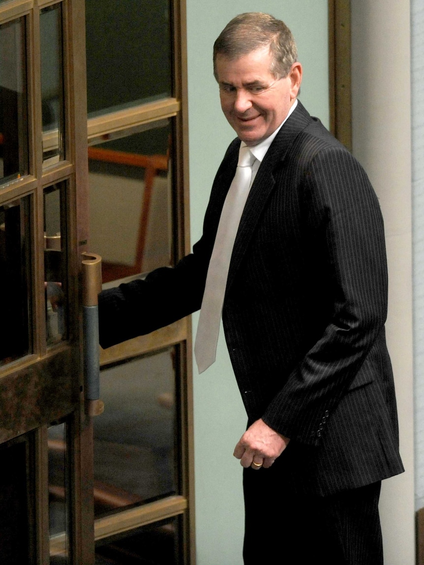Peter Slipper leaves the chamber after the election of Anna Burke as Speaker.