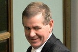 Peter Slipper leaves the chamber after the election of Anna Burke as Speaker.