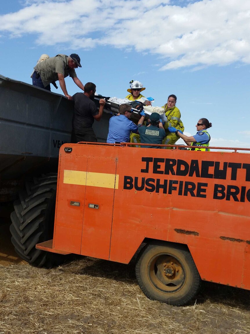 Farmers and emergency services work together to free Jason Holmes from the chaser bin