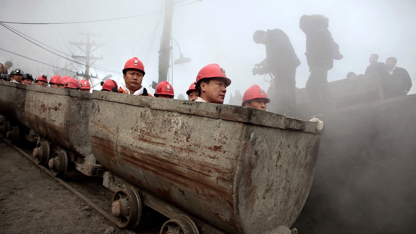 Rescuers enter the Xinxing coal mine to search for survivors following a gas explosion on November 22, 2009.