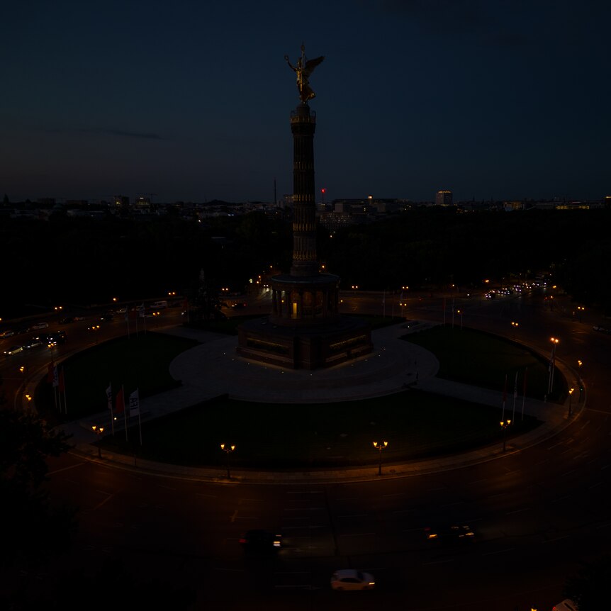 Berlin's victory column with golden angel on top in the semi-darkness 