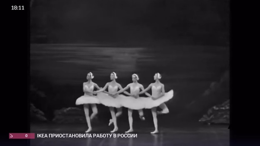 A black and white image of four ballerinas linking arms in Swan Lakes Dance of the Cygnets.