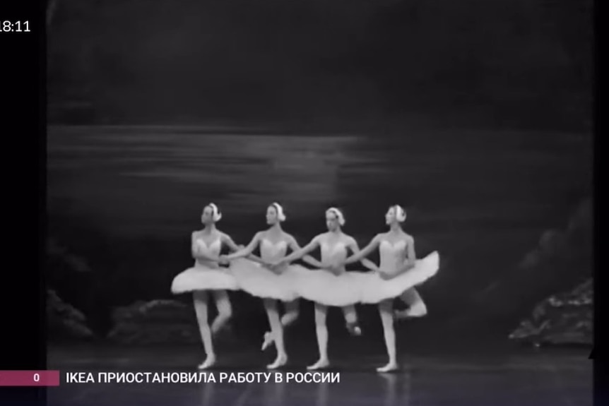 A black and white image of four ballerinas linking arms in Swan Lakes Dance of the Cygnets.