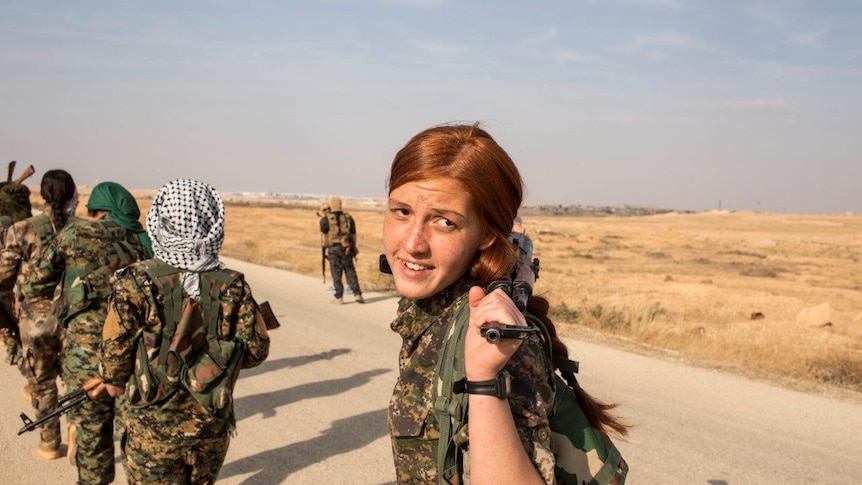 Arab girls walks with colleagues as they start a training session where they join with the Syrian Democratic Forces