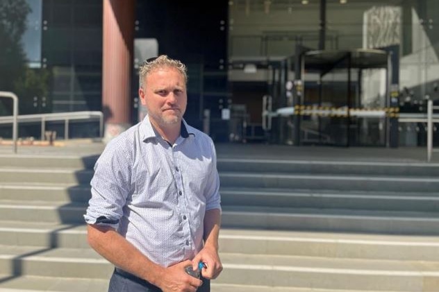 Man in front of building.