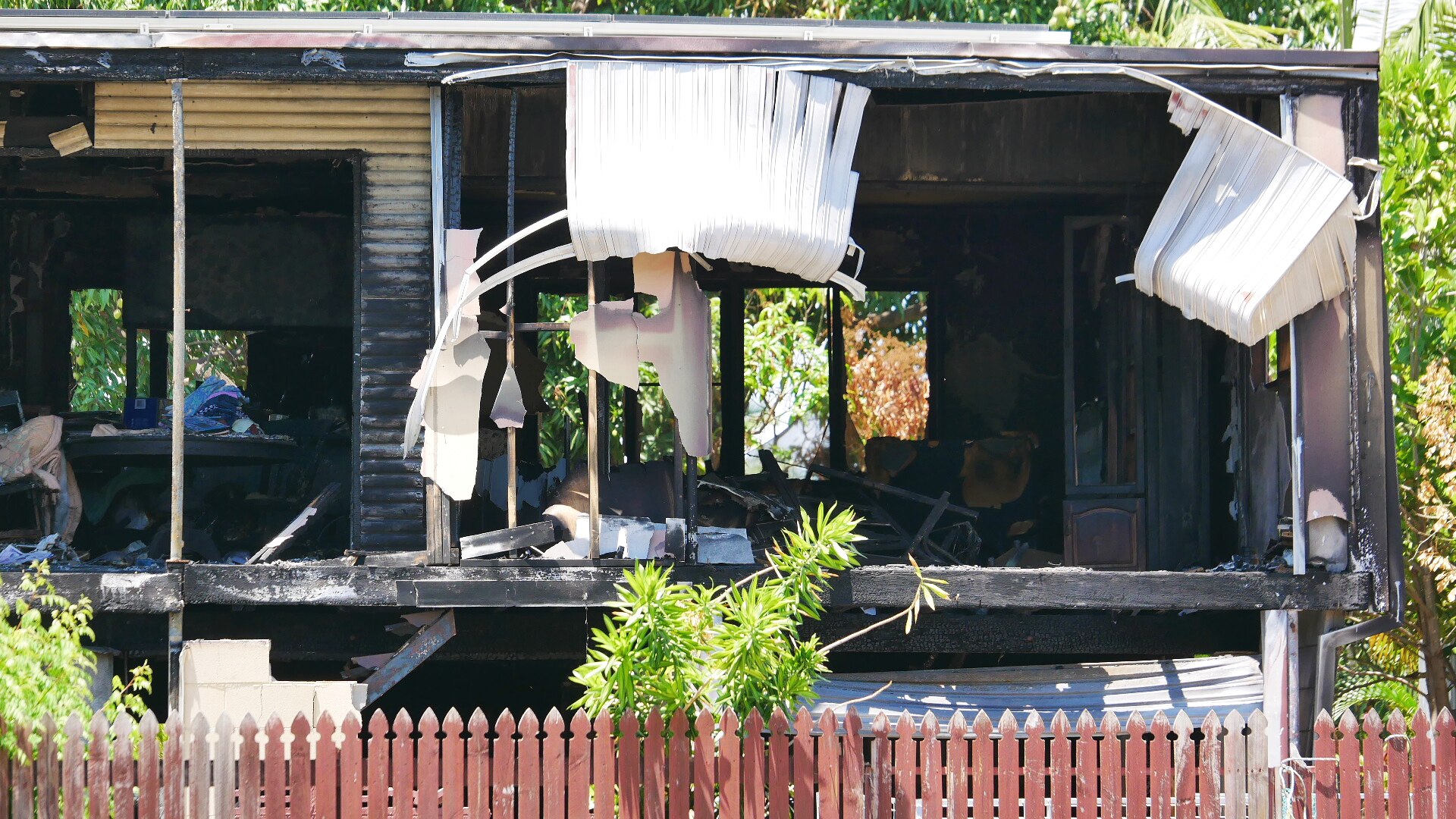 The burnt-out shell of a two-storey suburban home