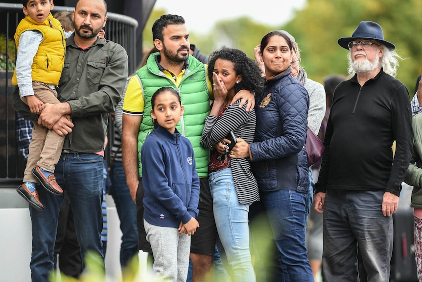 Members of the public pay their respects and mourn on Dean's Avenue in Christchurch.