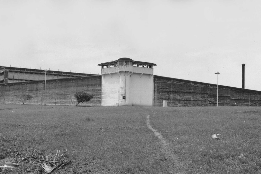 A black and white image of a prison exterior