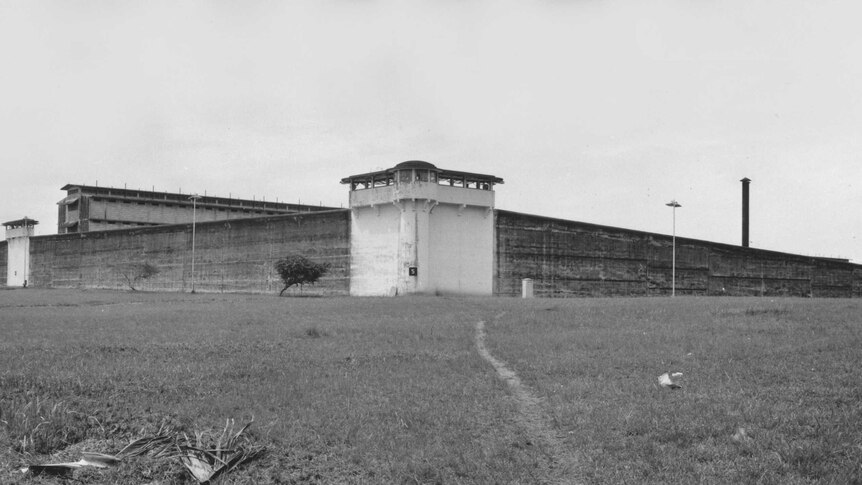 A black and white image of a prison exterior