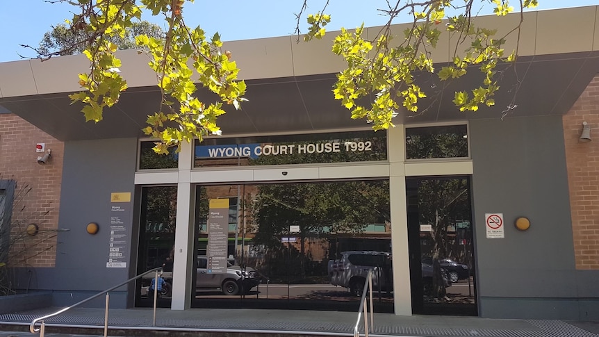 A single-storey brick building with grey cladding around its entrance and lettering that reads "Wyong Court House 1992".