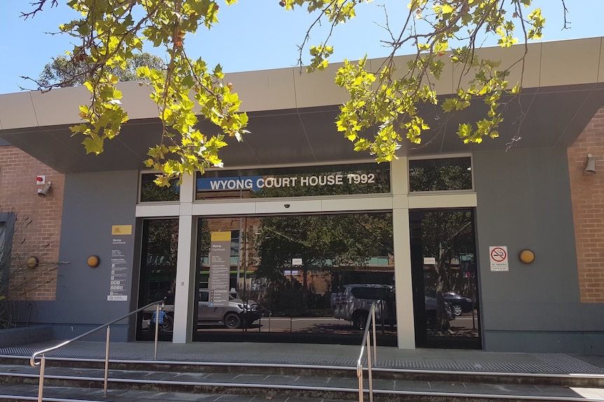 A single-storey brick building with grey cladding around its entrance and lettering that reads "Wyong Court House 1992".