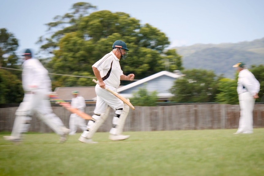 Doug Crowell running on cricket pitch.