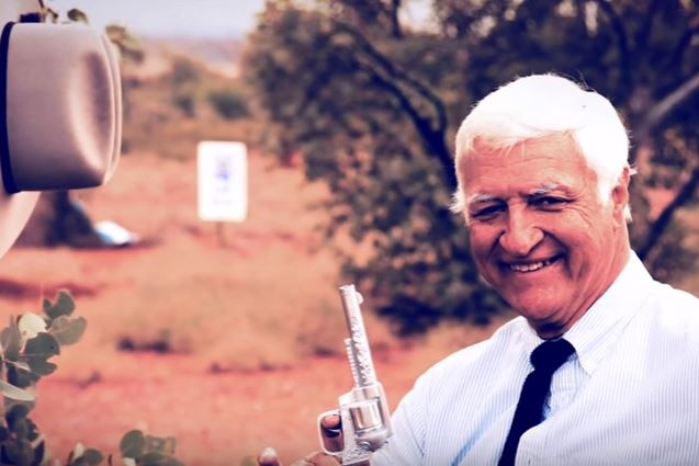 Federal MP Bob Katter holds a revolver.