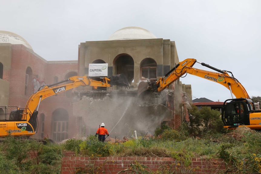 Two yellow diggers demolish the Taj on Swan.